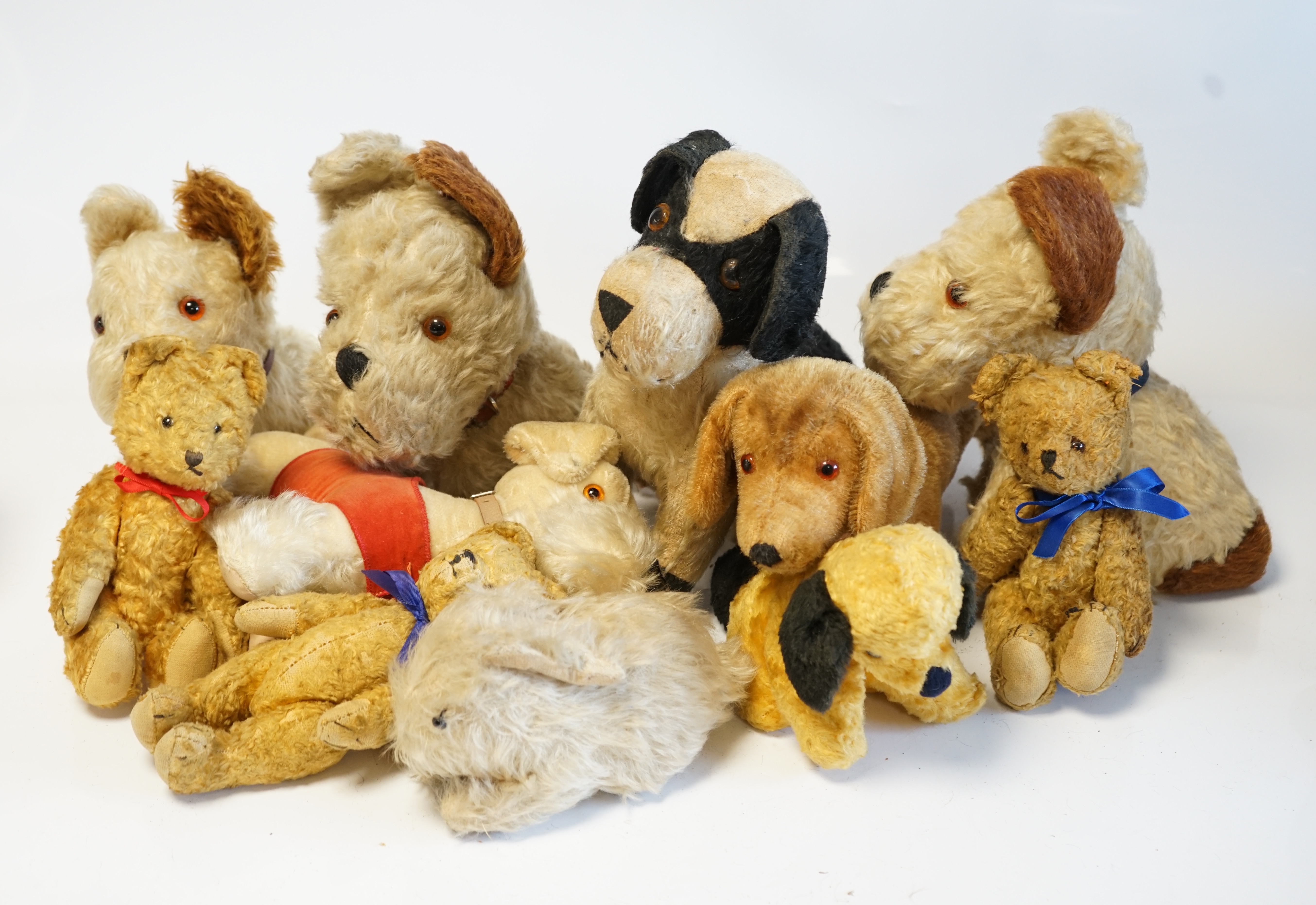 Four Merrythought dogs and three others, c.1950's, together with three cotton plush bears and one rabbit (11). Condition - fair